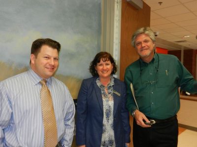 NTE Corporate Affairs Director Robert Hinkle (right) visits with Haltom High School administrators