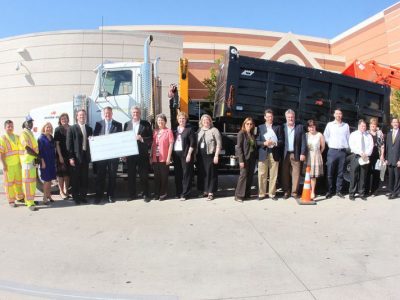 NTE project team and VIPs in front of construction vehicle