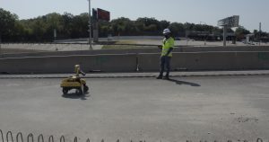 Tiny robot assists with roadway marking and striping.